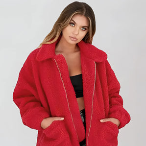Women's oversized red teddy coat with plush texture, featuring a wide collar and long sleeves, designed for warmth in winter.