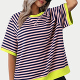 Women's oversized striped tee in pink and yellow, featuring a casual loose fit with short sleeves and a round neckline, showcased on a mannequin against a white background.