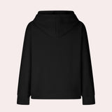 
A woman wearing an oversized textured black hoodie with a casual loose fit, featuring long sleeves and a comfortable collar.
