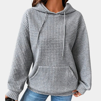 Women's oversized gray textured hoodie in a casual loose fit with long sleeves and a comfortable neck design, displayed on a white background.