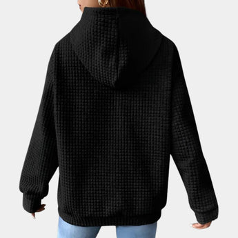 Women's oversized textured black hoodie with casual loose fit, featuring long sleeves, a comfortable neckline, and a relaxed shoulder design.