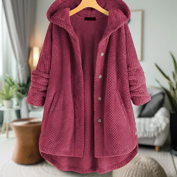 Women's pink oversized wool hooded sweater coat in 5XL, displayed on a mannequin with a focus on the collar and sleeve details; background includes a houseplant and curtains.