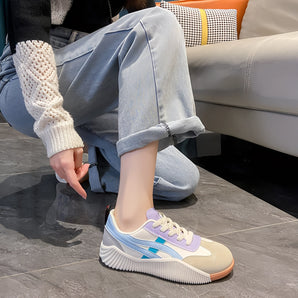 Women's pastel chunky sneakers featuring a stylish multi-color design, worn with visible lower legs and knees, embodying a blend of urban fashion and comfort.