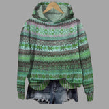 Women's patterned winter hoodie in a cozy alpaca blend featuring a boho style design in green. The hoodie is in a size 5XL and showcases intricate patterns with a mix of electric blue and magenta accents. The garment includes long sleeves and a round collar, made from woolen material.