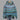 Women's blue patterned winter hoodie in a cozy alpaca blend with boho style design, featuring long sleeves and a comfortable collar.