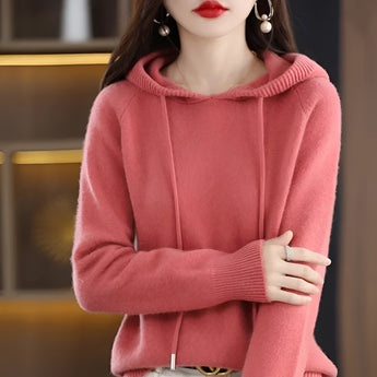 Women's pink hooded sweater in a soft knit material, featuring long sleeves and a cozy fit, perfect for winter wear.