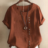 Women's oversized short sleeve blouse in pink linen featuring a relaxed fit, a simple collar, and casual styling, with a focus on comfort and easy fashion.