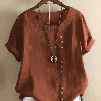 Women's oversized short sleeve blouse in pink linen featuring a relaxed fit, a simple collar, and casual styling, with a focus on comfort and easy fashion.