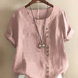 Women's oversized casual pink linen blouse with short sleeves, featuring a simple collar and crafted from natural material.