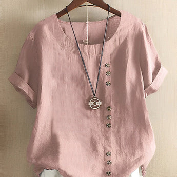 Women's oversized casual pink linen blouse with short sleeves, featuring a simple collar and crafted from natural material.