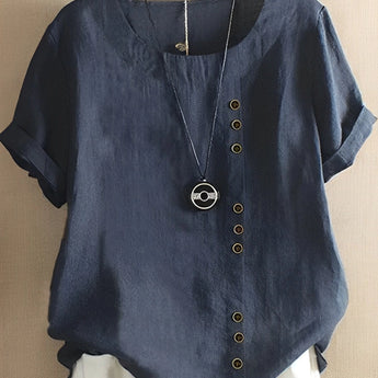 
Dark blue oversized women's blouse with short sleeves, a button-down design, and a collar, showcased on a mannequin.