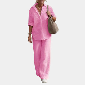 Women's pink linen suit featuring a casual summer set with a button-down shirt, shown in size XL. The suit highlights the outerwear design, focusing on the shoulder and sleeve details.