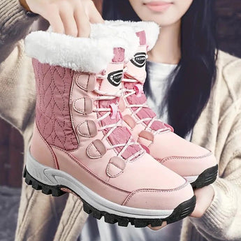 Women's pink quilted fur-lined waterproof winter boots featuring a stylish design, ideal for outdoor activities and cold weather.