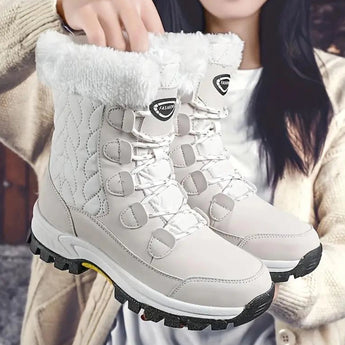 Women's pink quilted fur-lined waterproof winter boots displayed against a white background, showcasing their sturdy design and warm lining suitable for cold weather.