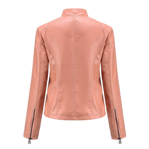 
A woman wearing a pink slim fit leather biker jacket, featuring a stylish collar and sleeves, paired with jeans. The jacket is designed as spring outerwear, highlighting the waist and neck area for a chic look.