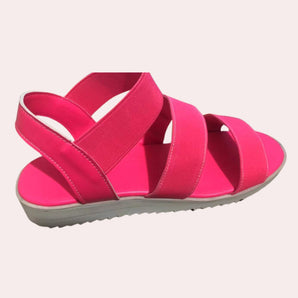 Women's pink platform sandals featuring a stylish and comfortable design with velcro straps, made from synthetic rubber.
