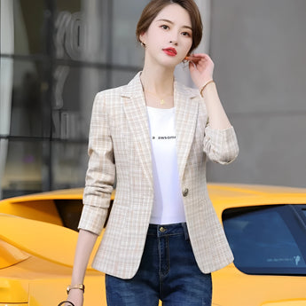 
A light tan women's plaid blazer in a casual chic style, suitable for office or street wear, shown on a mannequin with a dress shirt underneath, highlighting the blazer's tailored fit and elegant apricot hue in a 3XL size.