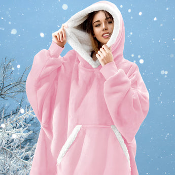 
Woman wearing a pink oversized fleece hooded winter robe, smiling and posing in a natural setting, emphasizing the comfort and warmth of the loungewear.