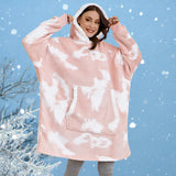 Oversized pink fleece hooded robe worn by a woman with long hair, highlighting the plush texture and cozy design, suitable for warmth and comfort in winter.