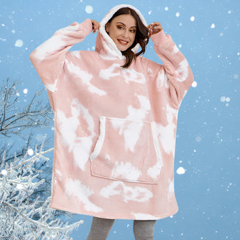 Oversized pink fleece hooded robe worn by a woman with long hair, highlighting the plush texture and cozy design, suitable for warmth and comfort in winter.