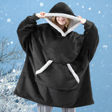 Women's black plush oversized fleece hooded winter robe with long sleeves, designed for warmth and comfort as loungewear.