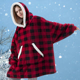 Women's oversized fleece hooded robe in a red and black tartan plaid pattern, designed for warmth and comfort during winter, with long sleeves and a plush texture.