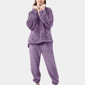 Women's purple fleece pajama set featuring a plush hoodie, long sleeves, and a cozy, comfortable design ideal for loungewear.