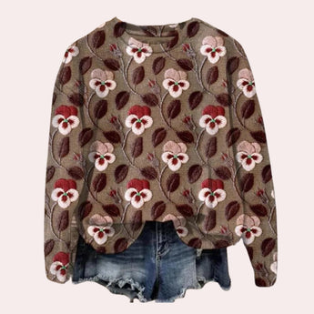 
A women's purple floral embroidered crewneck sweater featuring intricate floral designs, with long sleeves and a comfortable fit.