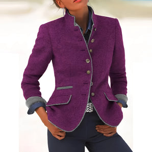 A women's purple wool blazer featuring tailored contrast cuffs, with a structured collar and long sleeves, highlighting the waist for a fitted look.
