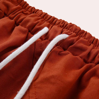 Women's red bohemian harem pants with elastic ankles and a drawstring waist, showcasing a comfortable and stylish design.