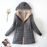 Alt text: A Women's gray fleece-lined hooded winter coat in size 3XL, designed as an insulated parka with a focus on warmth and comfort. The coat features a full-length design with a hood, long sleeves, and a high collar for added protection against cold weather.