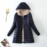 Dark blue women's fleece-lined hooded winter coat with a fur-trimmed collar, insulated for warmth, featuring long sleeves and a stylish design.