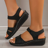 
A pair of women's red leather buckle sandals in size 43, featuring a stylish and comfortable design ideal for summer. The image shows the sandals being worn, highlighting their fashionable appeal and quality material.