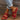 Red leather platform sandals for women, featuring a stylish design suitable for summer. The sandals have a comfortable platform sole, and they are displayed on a human foot to highlight their aesthetic and fit.