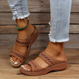 
Brown leather platform sandal on a woman's foot, worn with a leg visible, showcasing a stylish and comfortable summer shoe design.