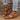 
Brown leather platform sandal on a woman's foot, worn with a leg visible, showcasing a stylish and comfortable summer shoe design.
