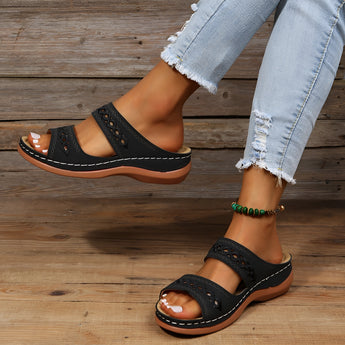 Women's red leather platform sandals worn on a model with denim jeans, showcasing a stylish and comfortable design suitable for summer.