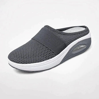 Dark gray women's mesh slip-on sneakers with breathable design and air-cushioned sole, ideal for walking and outdoor activities.