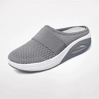 Women's gray mesh slip-on sneakers with breathable, air-cushioned sole, designed for comfort and outdoor activities.