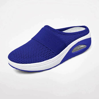 Women's red mesh slip-on sneakers with breathable design and air-cushioned sole, displayed against a plain background.