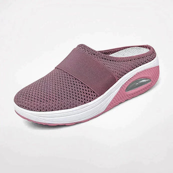 Women's pink slip-on sneakers with a breathable mesh design and air-cushioned sole, ideal for walking and outdoor activities.