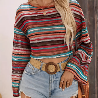 Women's retro striped knit crop top in a colorful bohemian style, featuring vibrant stripes and a cozy sweater texture, paired with white shorts.