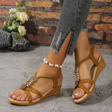Women's chic black rhinestone wedge sandals worn by a model, showcasing the summer fashion footwear with a stylish and elegant design.