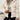 
A close-up image of a women's ribbed high collar insulated puffer jacket in beige color, size XL, featuring a stylish and cozy design with a high neckline and long sleeves.