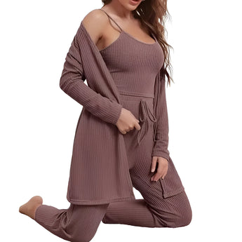 A woman wearing a purple ribbed knit cold shoulder jumpsuit, showcasing cozy fall loungewear with long sleeves, fitted waist, and styled with loose hair.