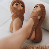 Women's brown ribbed slip-on slippers in size 43 placed on the grass, showcasing their cozy and lightweight design, ideal for comfortable wear.