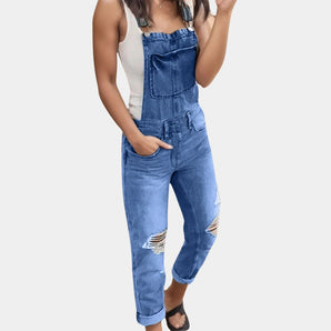 Dark blue women's ripped denim overalls jumpsuit in 3XL, featuring adjustable straps and distressed detailing, modeled to show its fit and fashion-forward design.