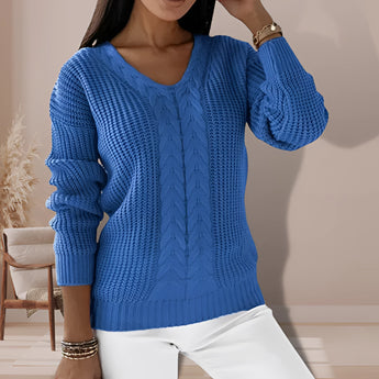 Women's sage green V-neck cable knit chunky sweater displayed on a mannequin, showcasing the detailed texture of the knit with focus on the shoulder, sleeve, and waist areas. The sweater has a relaxed fit with long sleeves, highlighting its cozy and warm design.