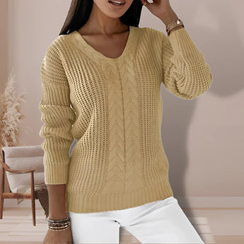 Women's sage green V-neck cable knit chunky sweater displayed on a mannequin, showcasing the detailed knit pattern with emphasis on the shoulder and sleeve design.