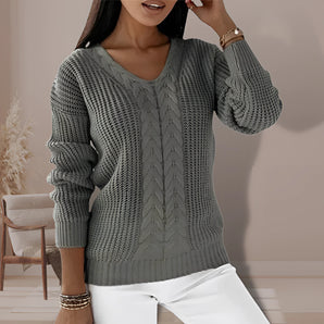 A plus-size gray cable knit chunky sweater featuring a V-neckline, long sleeves, and a relaxed fit, designed for women's comfort and style.